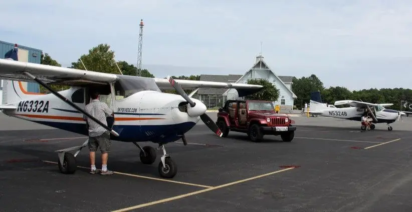 a small plane is parked in a parking lot